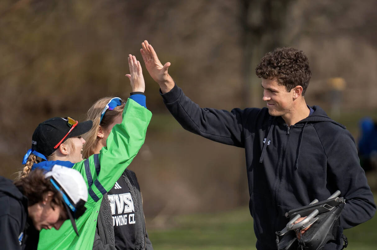 Rowers high five after competing a race